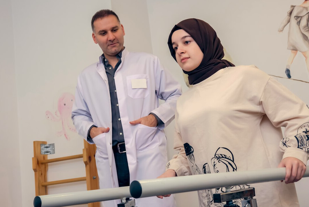 physiotherapist helping patient